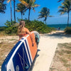 Women Carrying The Pioneer Paddle Board