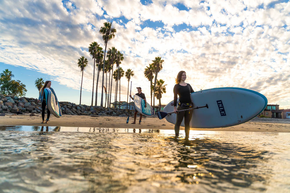 3 people carrying board