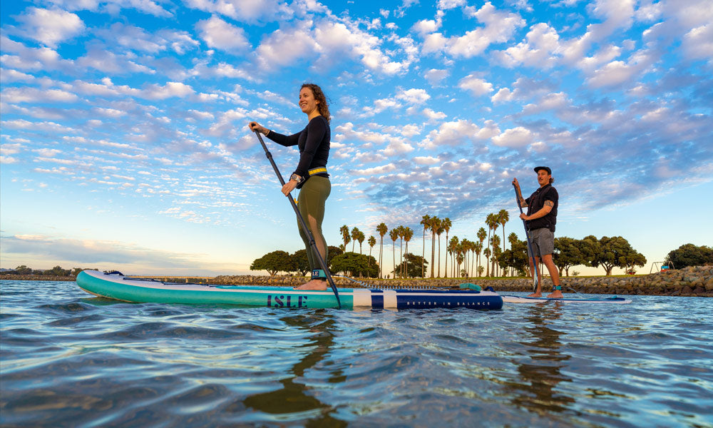 2 people paddling next to each other 