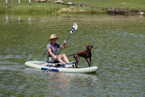 a man and his dog riding the ISLE switch hybrid paddle board kayak