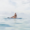 Women Laying On The Versa Paddle Board In The Water